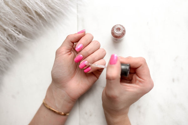 woman painting her nails at home